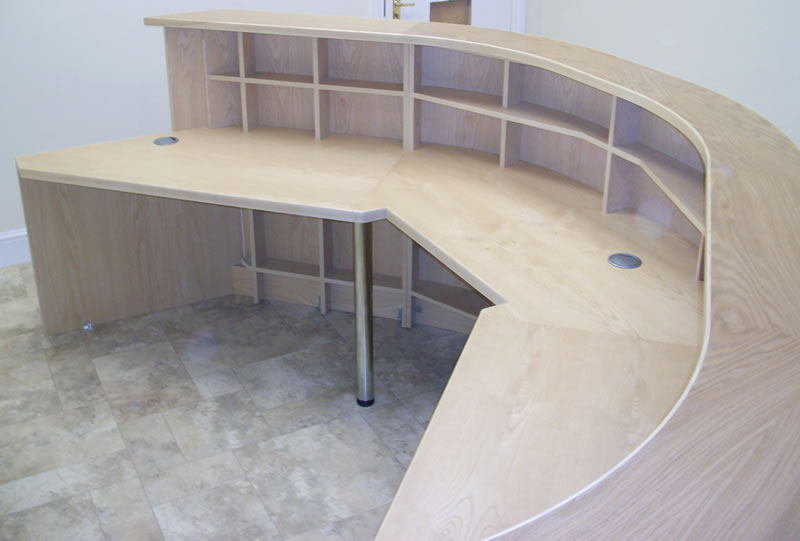 A curved bespoke reception desk made by Deco Bespoke